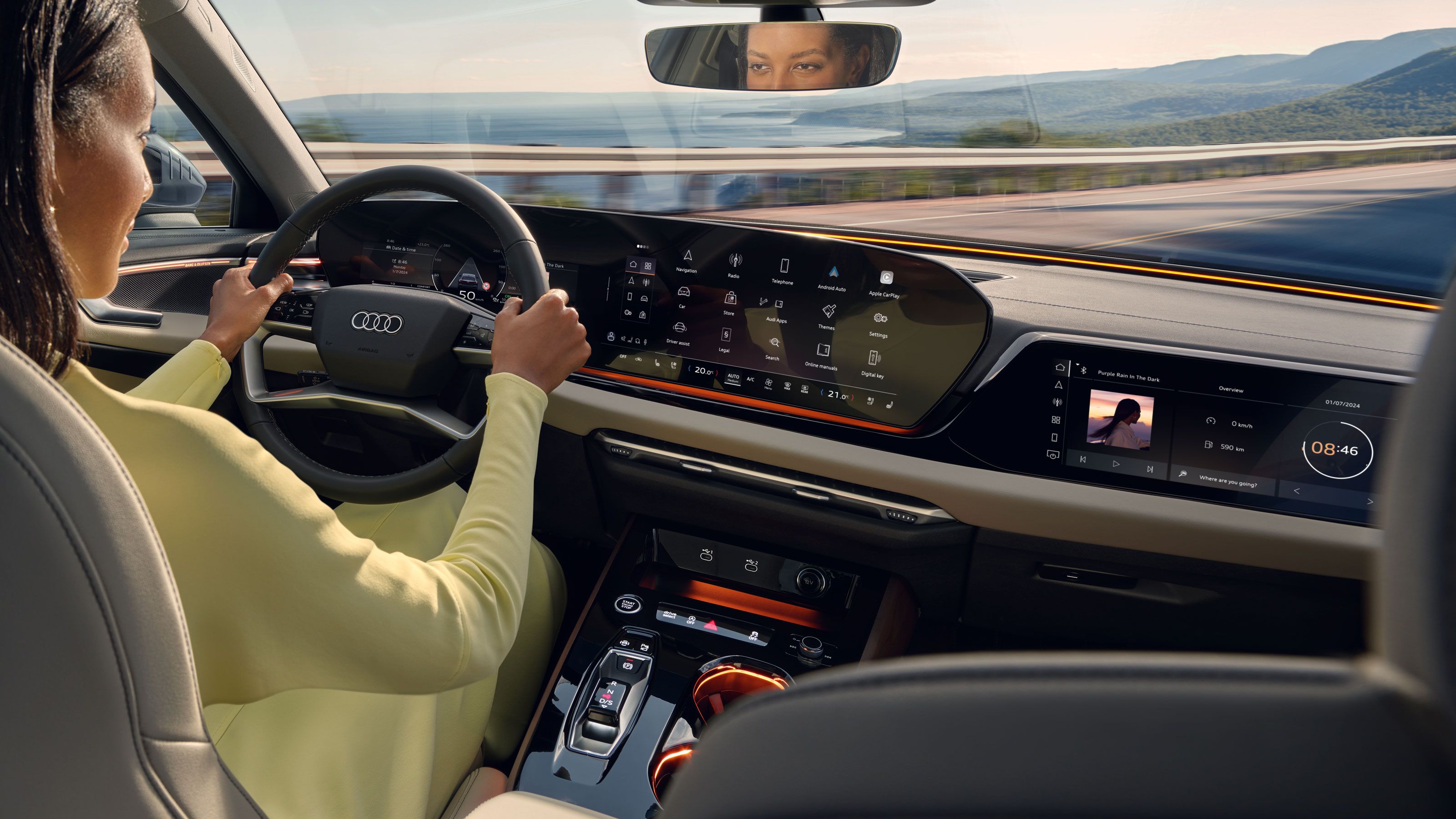 Жена държи волана на Audi автомобил, който управлява сред живописна местност