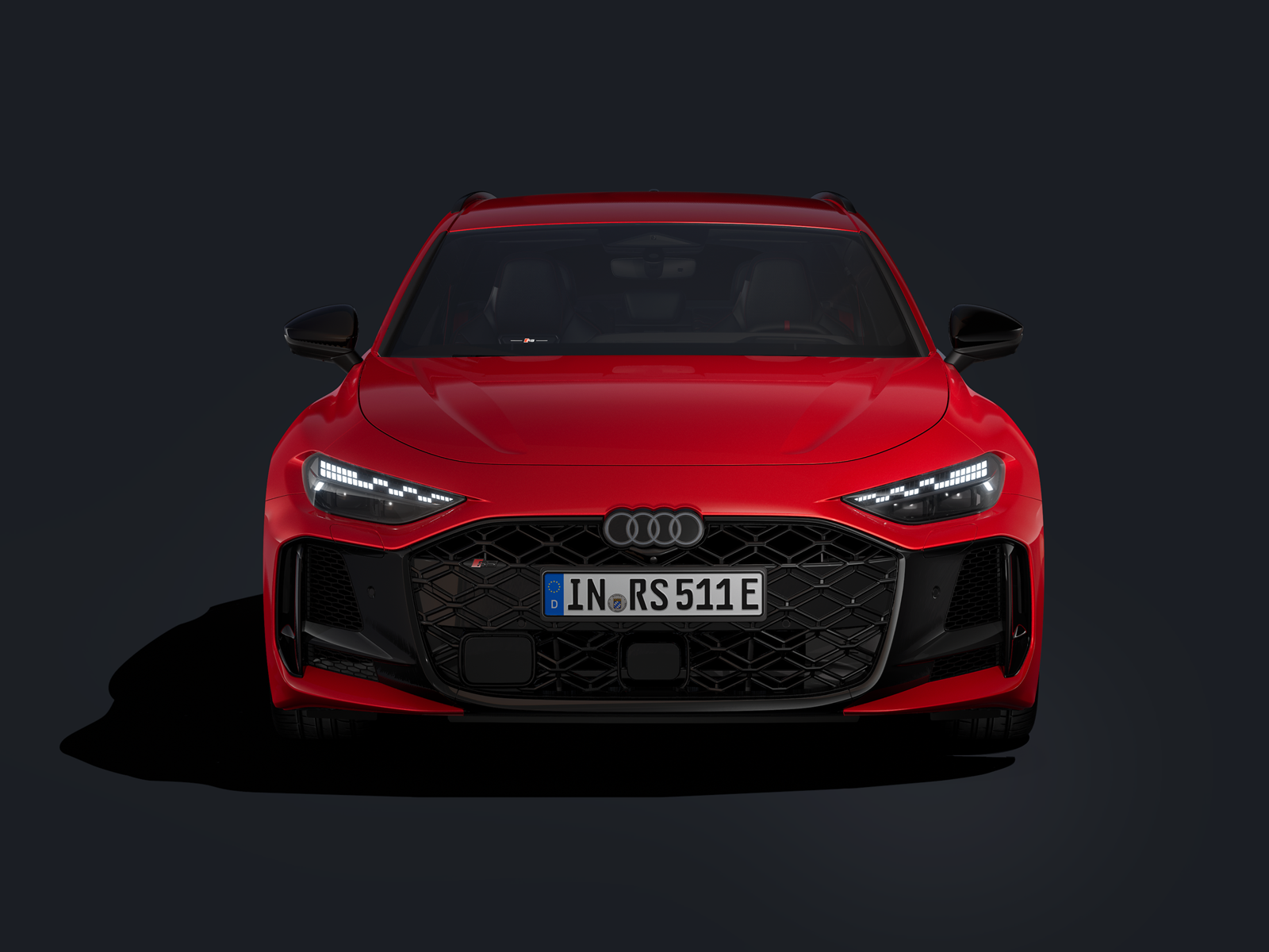 Ein roter Audi RS 5 Avant ist frontal abgebildet vor einem schwarzen Hintergrund.